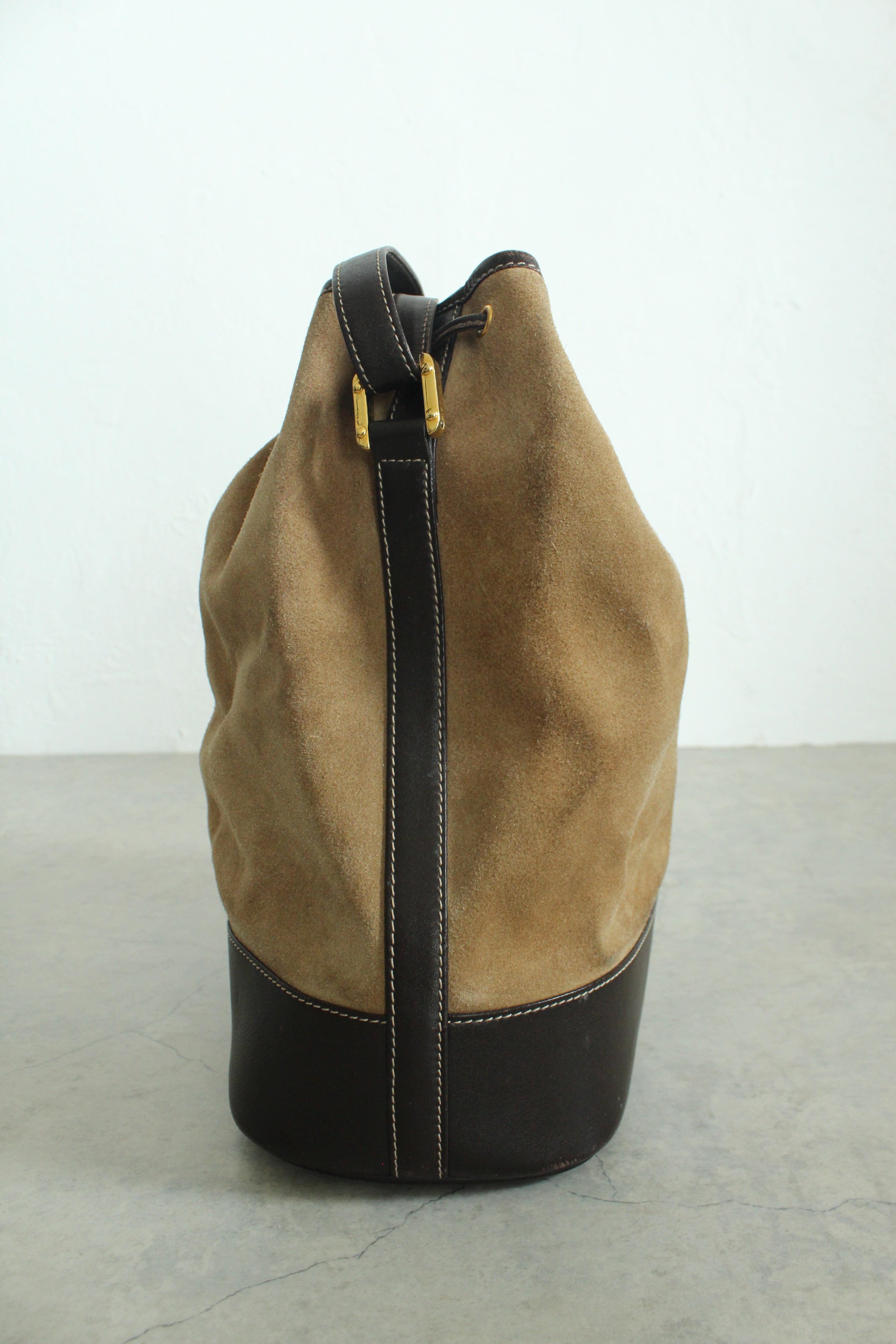 Anagram Suede Drawstring Bucket Bag