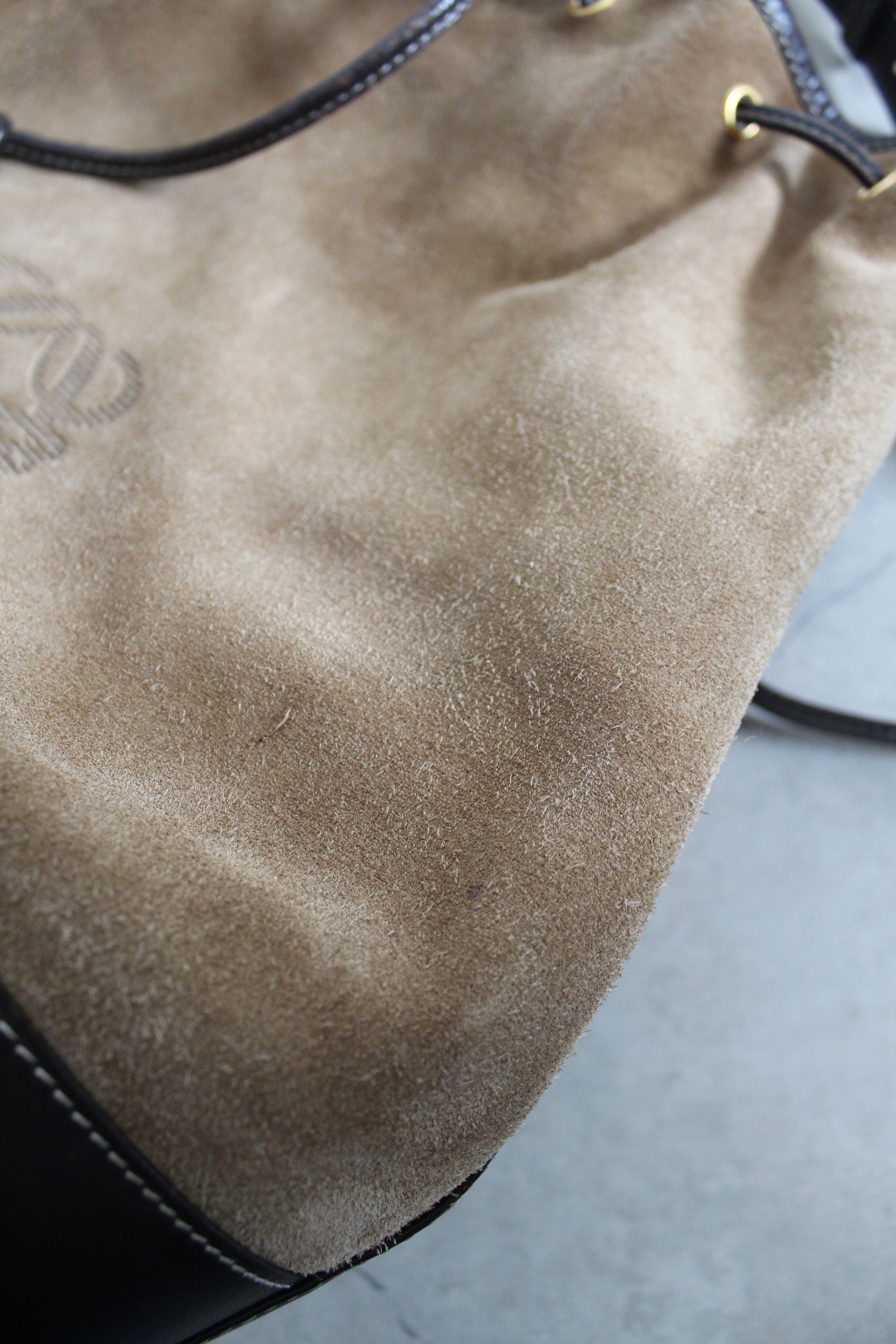 Anagram Suede Drawstring Bucket Bag