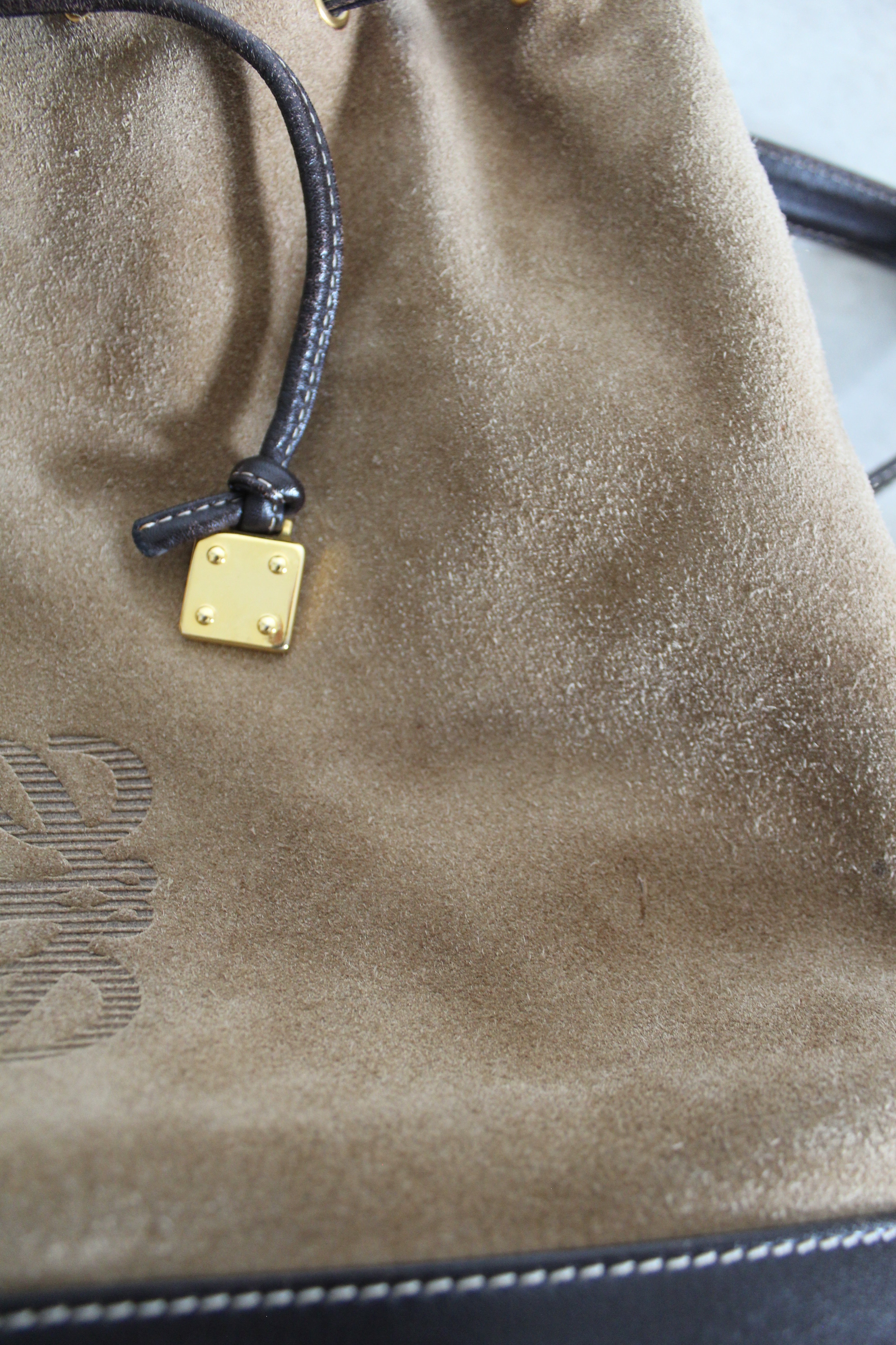 Anagram Suede Drawstring Bucket Bag
