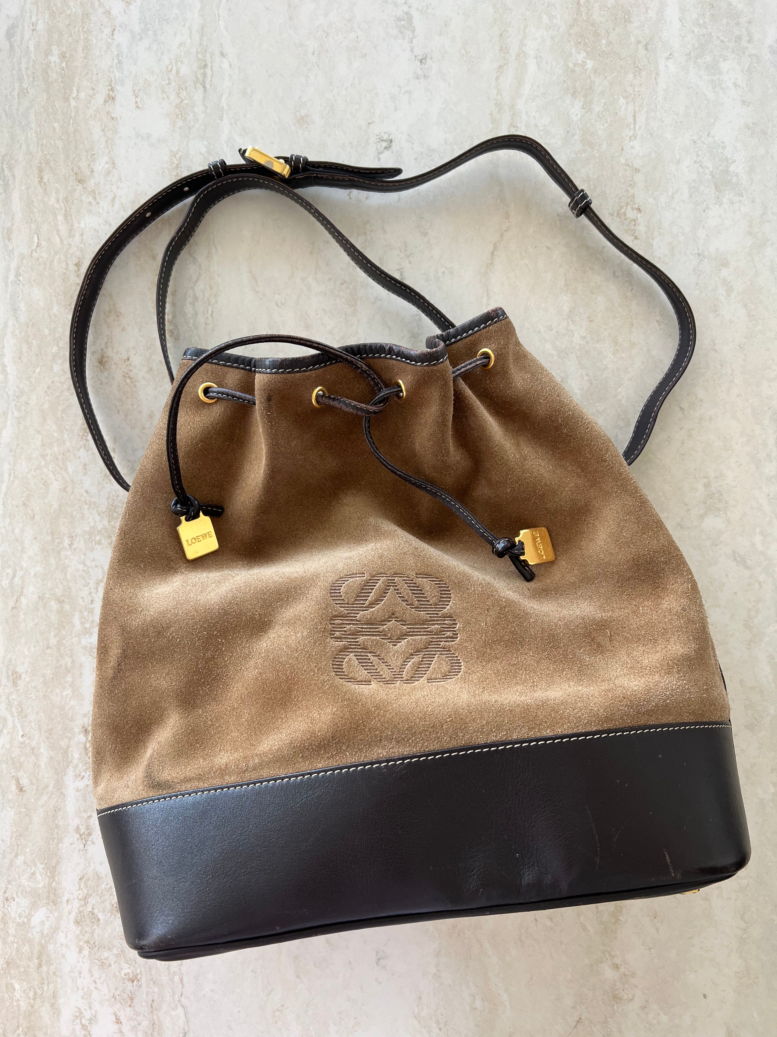Anagram Suede Drawstring Bucket Bag