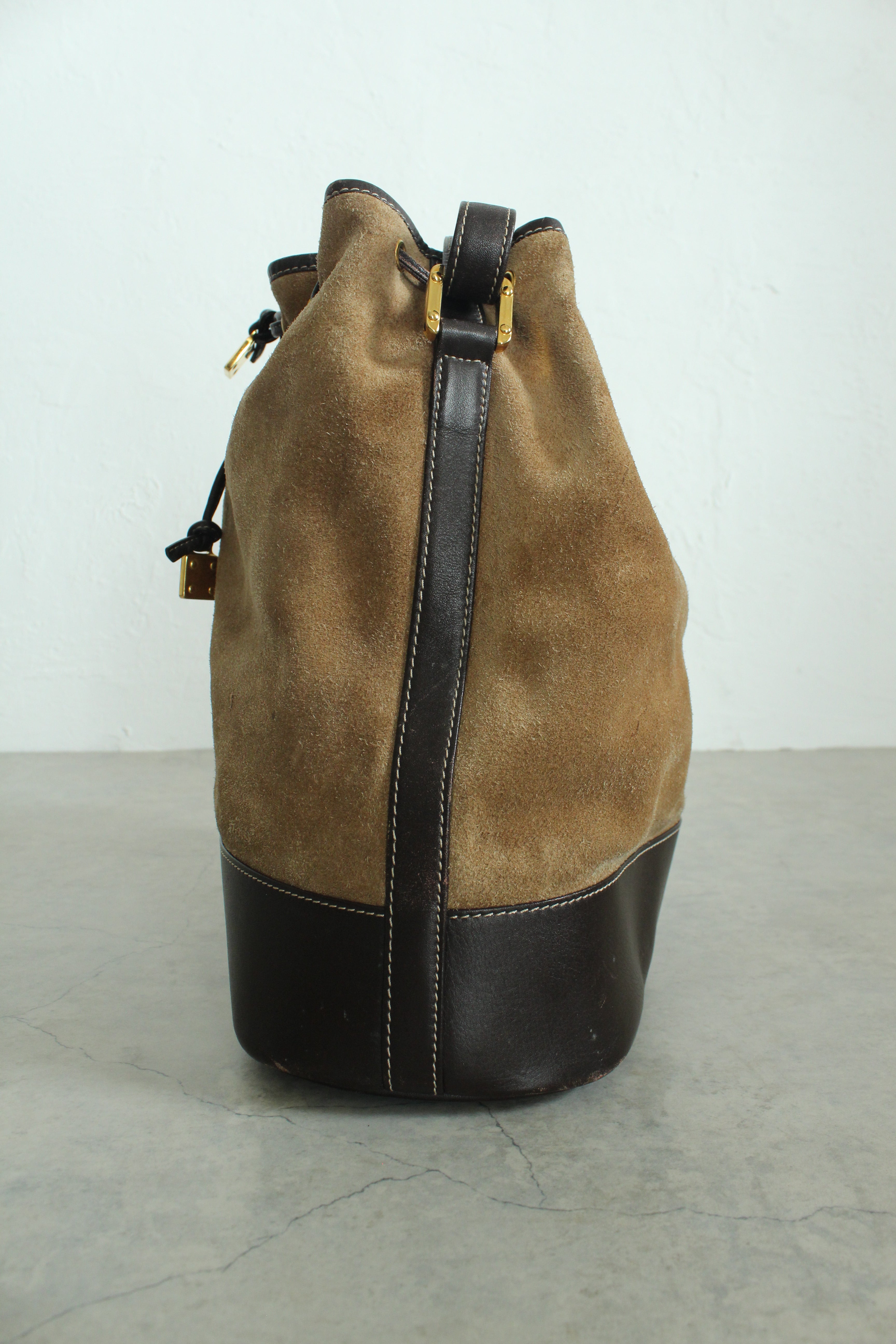 Anagram Suede Drawstring Bucket Bag