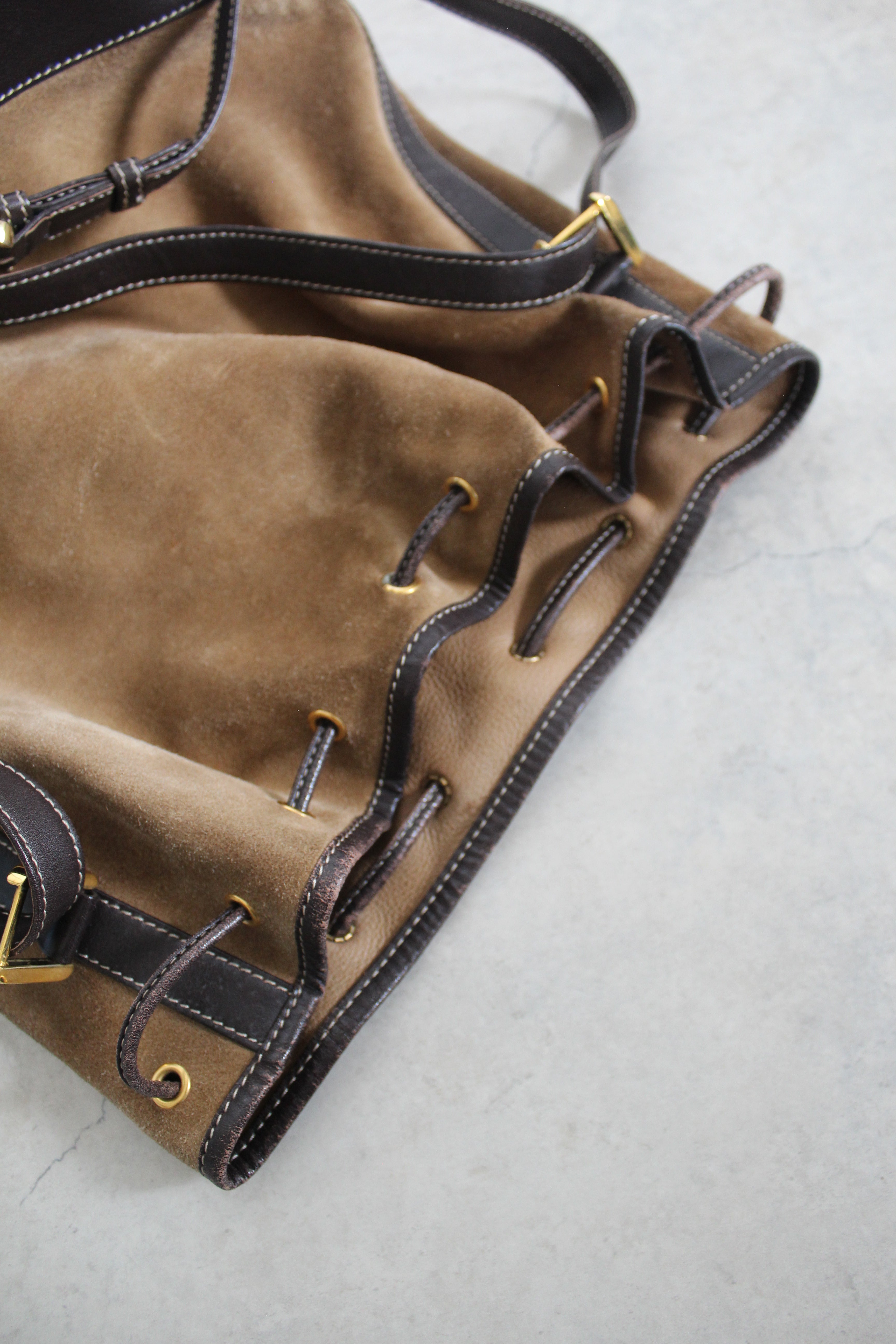 Anagram Suede Drawstring Bucket Bag